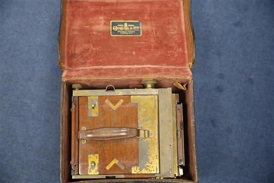 Ansel Adams (1902-1984), a rare Adams & Co. Minex De Luxe tropical mahogany and brass camera, 5 x 4in., the original leather case stamp